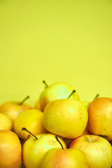 Modern minimalist still life with yellow apples on yellow background