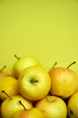 Modern minimalist still life with yellow apples on yellow background