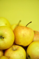 Modern minimalist still life with yellow apples on yellow background