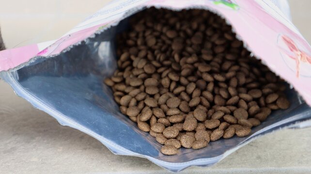 Pet food in a ziplock bag. Dry dog ​​food spilled from the package.