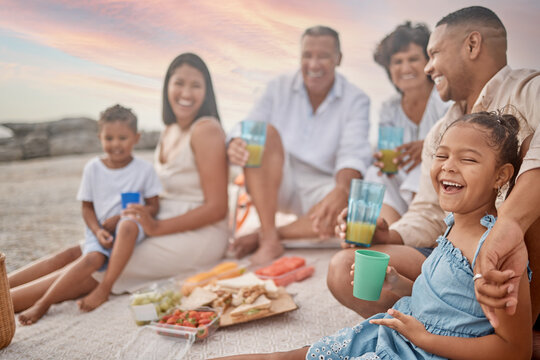 Happy family, beach and kid laughing at picnic for holiday, summer or travel. Lunch, food and people by sea with parents, generations or funny children drink juice at thanksgiving celebration outdoor - Powered by Adobe