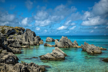 A picturesque scene of Tobacco Bay Bermuda with crystal-clear turquoise waters, reflecting the sunlight and enhancing the coastal allure