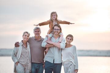 Portrait of grandparents, parents and kid on beach for bonding, relax and travel together in nature. Family generation, happy and mom, dad and girl by ocean for holiday, vacation and adventure by sea