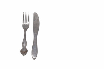 Metal fork and table knife on white isolated background. Horizontal.