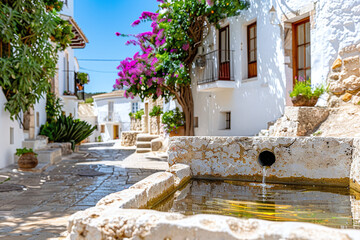 Naklejka premium a traditional stone cistern in a Mediterranean village, surrounded by whitewashed houses