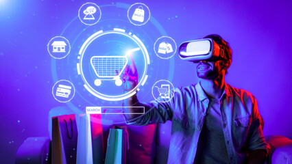 Happy man using VR headset and shopping online while sitting at sofa with shopping bags. Smart person looking at online market hologram and icon with neon background. Innovation technology. Deviation.