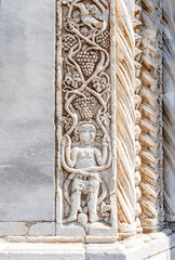 Bas relief on the cathedral gate of Concattedrale di Santa Maria Assunta, in the town of Orbetello, province of Grosseto, Tuscany region, Italy