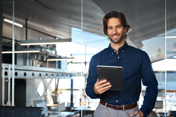 Happy male professional executive manager business owner holding tab computer looking at camera....