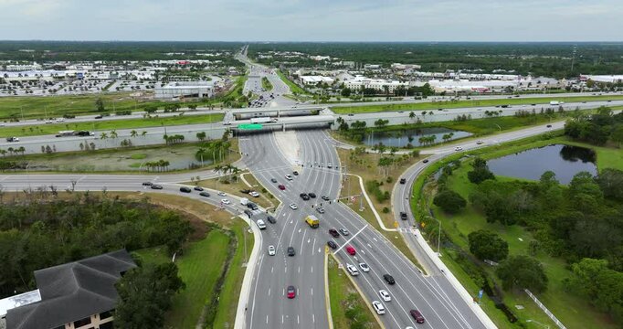 Diverging diamond interchange at highway intersection in Sarasota, Florida urban area. Traffic lights regulated junction lanes for express passing of cars.