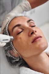 Woman receiving facial treatment in a spa during daytime