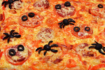 Halloween pizza with spiders and olive eyes