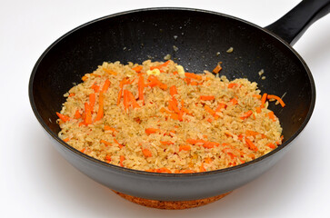 frying pan with rice and vegetables on a white background