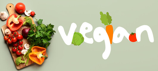 Wooden board with fresh vegetables and word VEGAN on grey background