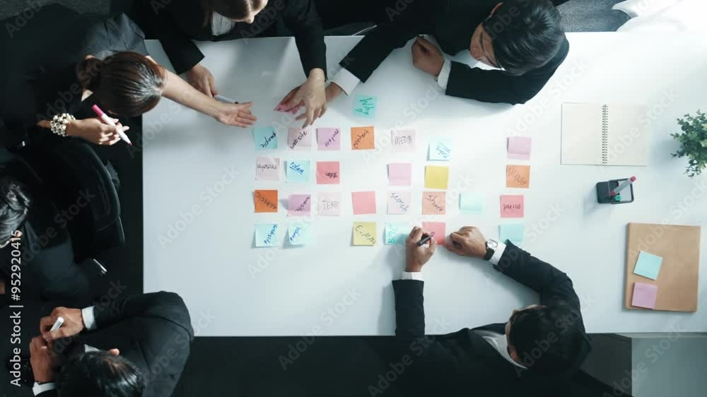 Poster top down view of professional business team working together to share idea while using colorful stic
