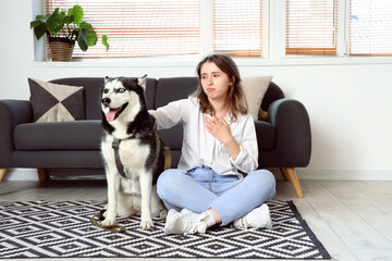 Depressed young woman with husky dog at home © Pixel-Shot