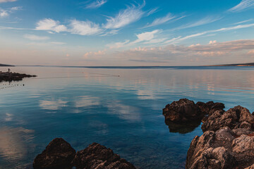 Krk Croatia27..06.24The stone shore of the bay on the background of the old town