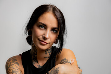 Portrait of a Tattooed girl in black tank top