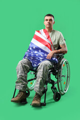 Young soldier in wheelchair with USA flag on green background. Veterans Day celebration