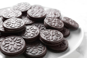 Tasty sandwich cookies on white marble table, closeup