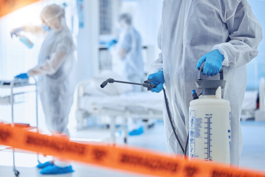 Hospital, biohazard and people cleaning with disinfection for contamination, safety or protocol. Medical, red tape and work with PPE in ward for healthcare compliance, sanitation or infection control