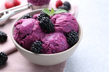 Delicious blackberry sorbet, mint and fresh berries on grey table, closeup