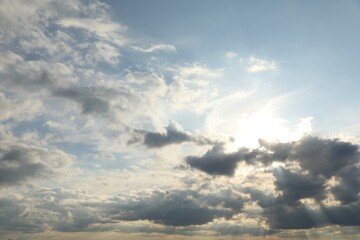 Sun shining through clouds on beautiful sky