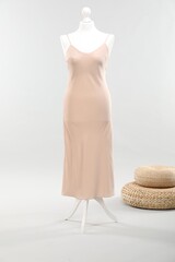 Mannequin with new stylish dress on light grey background