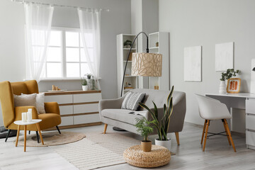 Armchair, sofa and big lamp in living room
