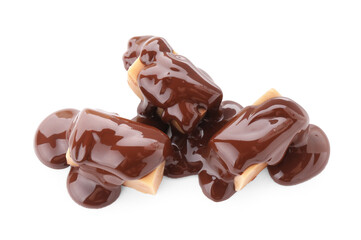 Delicious caramel candies with melted chocolate isolated on white
