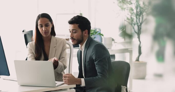 Two business partners met in office review contract details, terms and conditions, watching and discuss online presentation sit at desk using laptop, take part in negotiations, planning cooperation