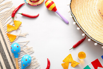 Frame made of Mexican symbols, nachos and tequila on light background. El Dia de Muertos