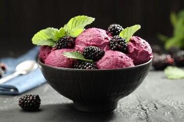 Delicious blackberry sorbet, fresh berries and mint in bowl on gray textured table, closeup