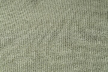Texture of olive knitted fabric as background, closeup