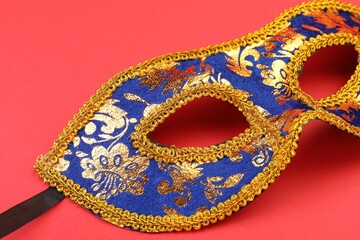 One beautiful carnival mask on red background, closeup