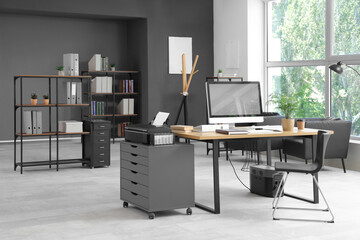 Interior of stylish office with workplace, modern computer and chair