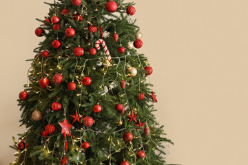 Glowing Christmas tree on beige background