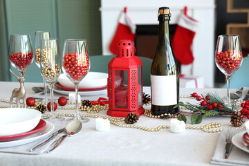 Christmas table setting with beads and lantern in room, closeup