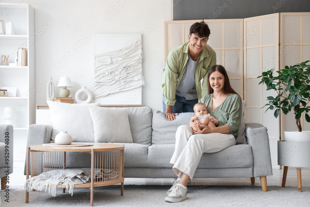 Poster young parents with their little baby at home