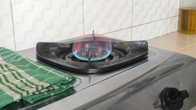 Turning off the gas stove in the kitchen