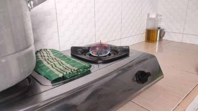 Turning on the gas stove in the kitchen