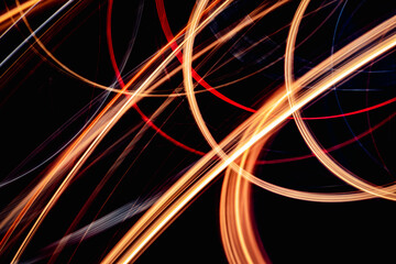 A series of colorful, swirling lines on a black background. The lines are bright and dynamic, creating a sense of movement and energy. The image is abstract and open to interpretation