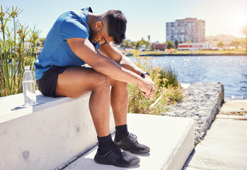 Sad, tired runner or man in city on break in outdoor exercise, fitness challenge or running sports. Upset, anxiety or exhausted athlete disappointed by stress, low energy or depression in training