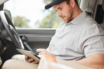 Reading, tablet or delivery man in van to search for directions to location or shipping address. Online order, logistics or courier worker in car vehicle for ecommerce package, supply or checklist © Flashizzle/peopleimages.com