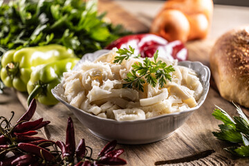 Precooked beef tripes in a bowl with vegetables and herbs ready for cooking