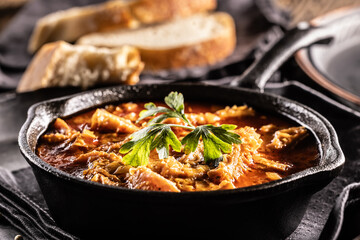 Tasty soup or stew made of beef tripe and spices. Spicy and aromatic tripe soup seasoned with pepper and served with bread