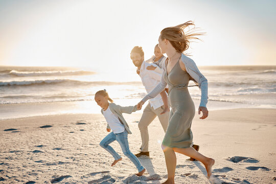 Beach, family and running with kids at sunset for outdoor vacation, adventure and weekend trip. Happy, father and mother with children by ocean in summer for journey, travel and holiday in Florida