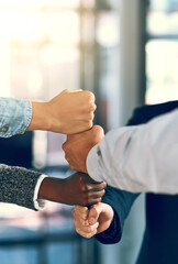 Business people, fist and stack in office for teamwork, inclusion or equality with motivation for...
