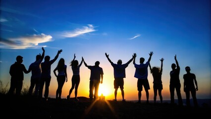 Obraz premium Silhouettes of a Group of People Standing with Arms Raised at Sunset
