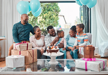 Birthday cake, gifts and black child with family at party with balloons for celebration at home. Happy, presents and African girl with dessert for special event with grandparents, parents and brother