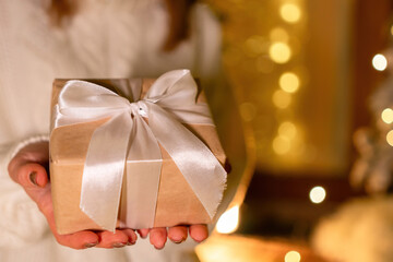 Christmas present in hands or gift box on magical bokeh background. Beautiful Christmas gift boxes...